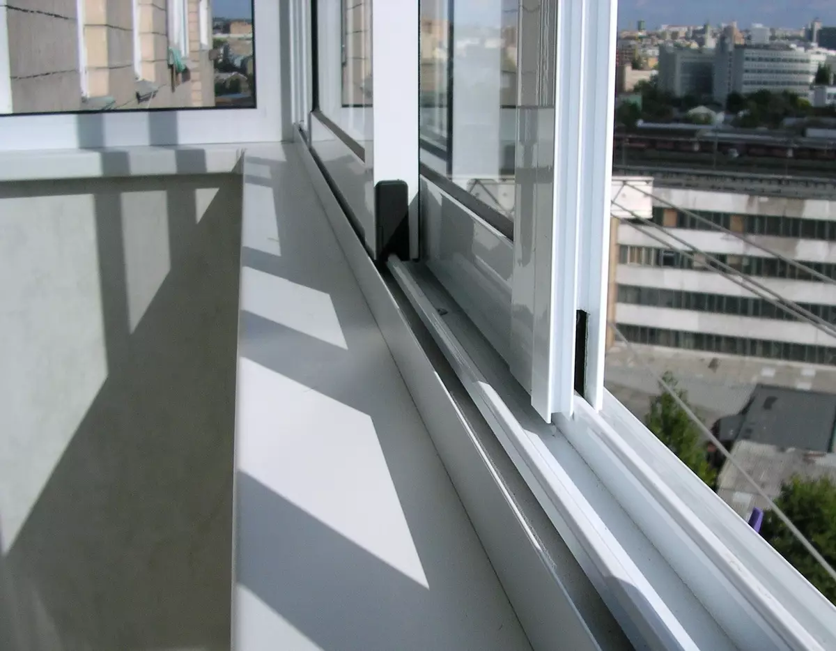 Balkoni kaca oleh profil aluminium (51 foto): Ciri-ciri Balkon Aluminium Bingkai, jenis tingkap kaca yang sejuk dan hangat, sistem cahaya dan bengkak 10026_2