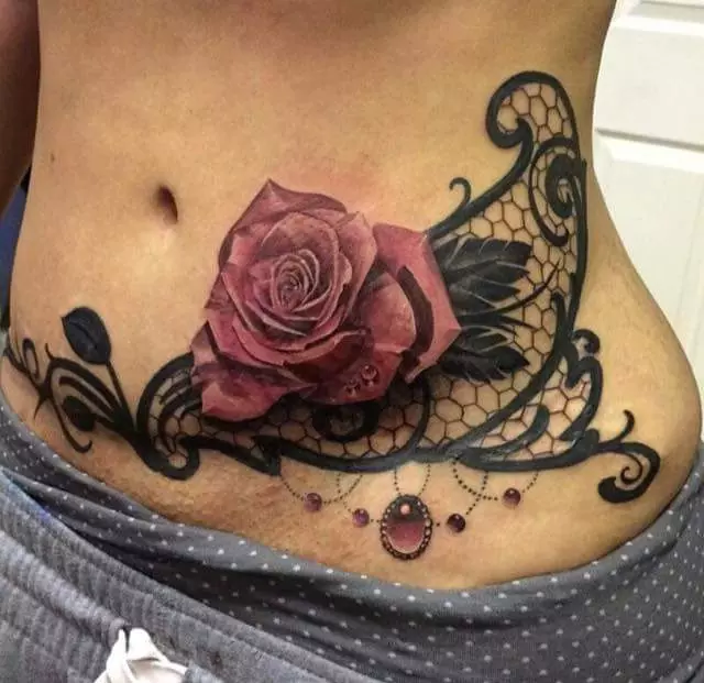 Tattoo na želodcu za dekleta (61 fotografij): skice. Tetovaže na dnu trebuha in okoli popka po porodu, majhna lepa tattoo in velika 13772_7