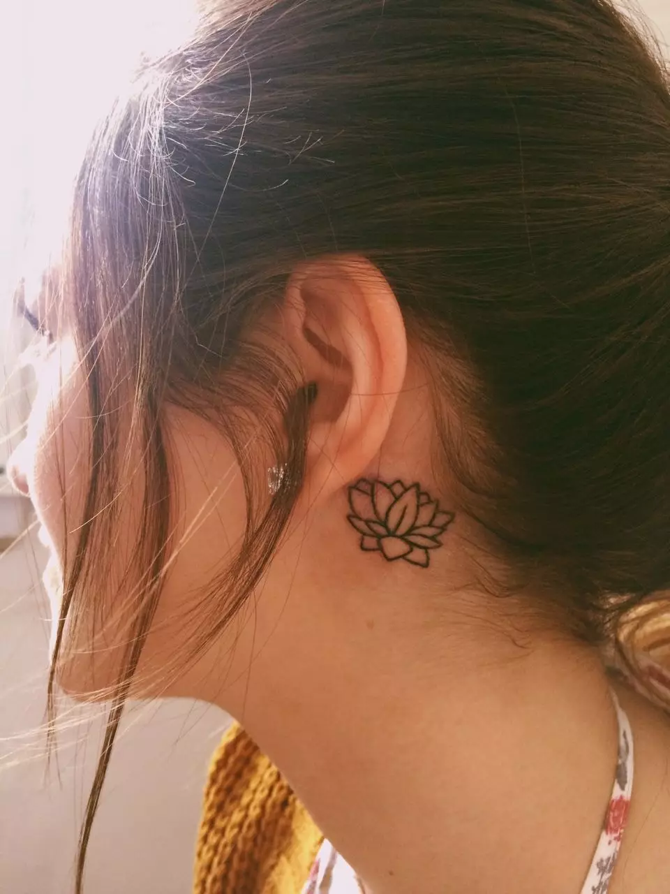 Tattoo za uho za dekleta (39 fotografij): skice majhnih tetovaž, vrednost ženskega mini-tatona, tetovaže z zvezdami in napisi, kače in perje, druge možnosti 14190_28