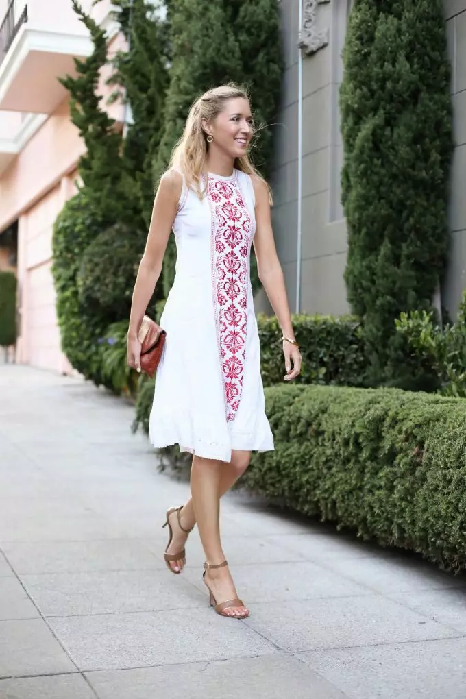 Red embroidery on a white linen dress