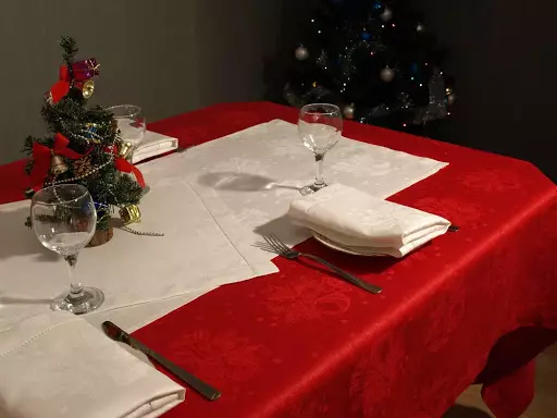 Tablecloths vermelhos: em uma mesa redonda de 180 cm e retangular, em uma gaiola e toalhas de mesa monocromáticas. Métodos de servir. Toalha de mesa de linho com flocos de neve e outras opções 21598_5