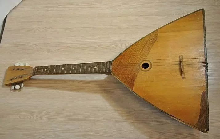 Large Balalaika (24 wêne): Balalaika-Bass di orkestraya gel de. Meriv çawa amûrek muzîka mezin a ku li ser masê radiweste? 25511_9