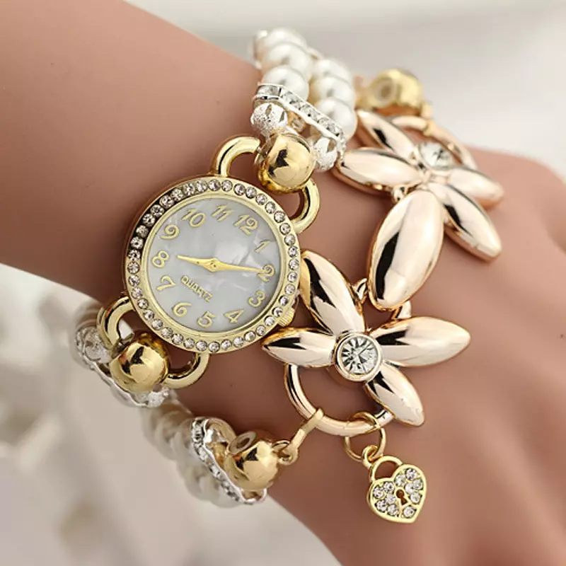 Goldene Uhr mit einem goldenen Armband (77 Fotos): Frauengoldmuster 3559_39