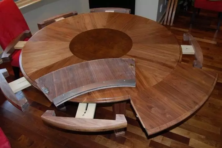 Mesa deslizante para a sala de estar: Dicas para escolher uma grande mesa de jantar oval e redonda. Revisão de mesas bonitas e modernas da produção russa. Exemplos interessantes 9732_6